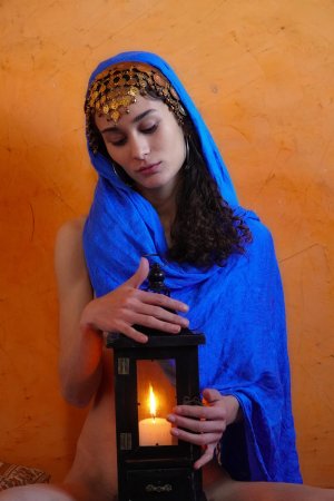 Naomi T posing spread-legged with necklaces and candles in a sensual indoor setting — Naomi T #1