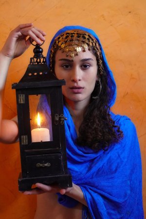 Naomi T posing spread-legged with necklaces and candles in a sensual indoor setting — Naomi T #2