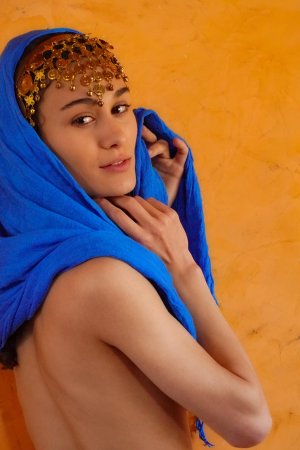 Naomi T posing spread-legged with necklaces and candles in a sensual indoor setting — Naomi T #9