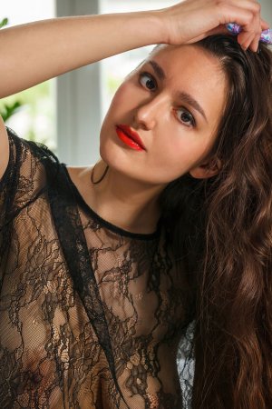 Adeline spreads her legs teasingly on the bed in sheer lace and fishnet stockings — Adeline #1