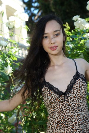 Djessy teases her leopard slip, then bares her pussy savage to the garden light — Djessy #1